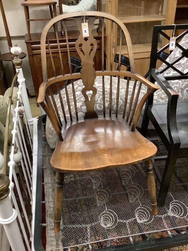 An early 20th century elm and beech Windsor comb back elbow chair, width 52cm, depth 50cm, height 98cm
